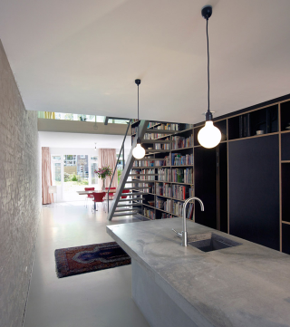 Illustration for article titled This Dream House Was Entirely Built Around a Giant Three-Story-High Bookshelf